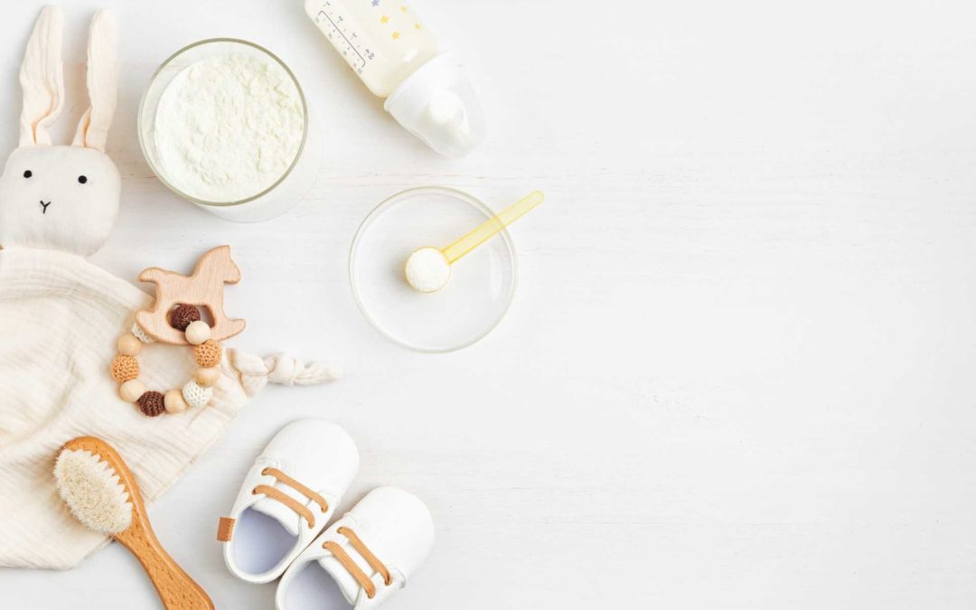 Cute baby toys with baby shoes, formula, a hair brush, and baby bottle.